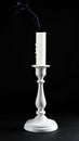 Extinguished candle in candlestick on black background Royalty Free Stock Photo