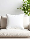 Blank White Pillow on Beige Sofa with Greenery Royalty Free Stock Photo