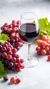 Fresh ripe grapes and a glass of wine on a gray table, close up. Royalty Free Stock Photo