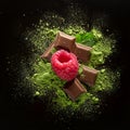 Assorted chocolate pieces with matcha powder and fresh raspberries on dark background, AI-generated Royalty Free Stock Photo