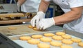 Gloved Worker Carefully Inspecting Cookies in Bakery Production Facility Royalty Free Stock Photo