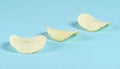 Three Thick-Cut Sea Salt Kettle Chips Side by Side on Pastel Blue Matte Background Royalty Free Stock Photo