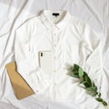 Minimalist White Shirt Flat Lay with Smartphone and Eucalyptus Royalty Free Stock Photo