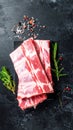 Raw ribs with rosemary and salt on black table, closeup Royalty Free Stock Photo
