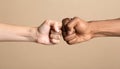 International relationships. People making fist bump on light brown background Royalty Free Stock Photo