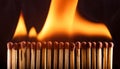 A row of wooden matches on fire Royalty Free Stock Photo