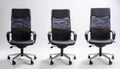 Three identical modern office chairs are arranged side by side Royalty Free Stock Photo