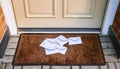 Several white envelopes are scattered on a brown coir doormat Royalty Free Stock Photo