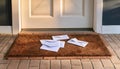 Several white envelopes are scattered on a brown coir doormat Royalty Free Stock Photo