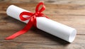 Graduation diploma tied with red ribbon on wooden table, closeup Royalty Free Stock Photo
