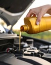 Draining engine oil from the bottle into the car engine, closing Royalty Free Stock Photo