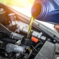 Draining engine oil from the bottle into the car engine, closing Royalty Free Stock Photo