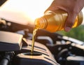 Draining engine oil from the bottle into the car engine, closing Royalty Free Stock Photo