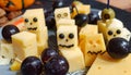 Halloween-themed charcuterie board with spooky cheese cuts, olives, and dark grapes Royalty Free Stock Photo