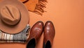 Flat Lay of Leather Ankle Boots, Wool Scarf, and Wide-Brimmed Felt Hat on Matte Burnt Orange Surface Royalty Free Stock Photo
