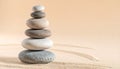 Stacked Smooth River Stones in Zen Balance on Matte Light Sand Background Royalty Free Stock Photo