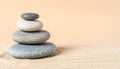 Stacked Smooth River Stones in Zen Balance on Matte Light Sand Background Royalty Free Stock Photo