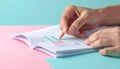Macro shot of hand turning pages of financial documents on pastel matte background Royalty Free Stock Photo