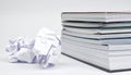 Crumpled Paper Balls Next to Neatly Stacked Homework Assignments Royalty Free Stock Photo