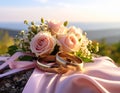 The wedding rings are tied with ribbons and beautiful flowers on pink fabric Royalty Free Stock Photo