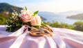 The wedding rings are tied with ribbons and beautiful flowers on pink fabric Royalty Free Stock Photo