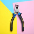 Combination pliers on color background, top view Royalty Free Stock Photo