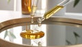 Close-Up of Glass Dropper Releasing Facial Oil onto Mirror Surface Royalty Free Stock Photo