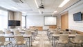 Modern Classroom with Digital Projector, Smartboard, and Neatly Aligned Chairs in Soft Neutral Tones Royalty Free Stock Photo