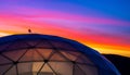 generated using AI.Geodesic dome structure with a triangular pattern, partially visible against a vibrant sunset. Royalty Free Stock Photo