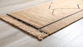 Close-Up of Natural Fiber Rug Corner on Wooden Floor Royalty Free Stock Photo