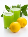 Fresh juicy lemons and a green drink on a white background. Royalty Free Stock Photo