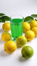 Fresh juicy lemons and a green drink on a white background. Royalty Free Stock Photo