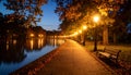 Quiet lakeside path with streetlight reflections Royalty Free Stock Photo