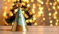 Colorful party hat on table with blurred glowing string lights background Royalty Free Stock Photo