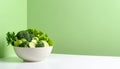 Bowl of mixed fresh vegetables on matte pastel green gradient background, symbolizing healthy nutrition Royalty Free Stock Photo