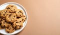 Chocolate chip cookies on white plate on matte light brown gradient background Royalty Free Stock Photo