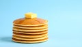 Stack of pancakes with syrup and butter on pastel blue gradient background Royalty Free Stock Photo