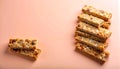 Stacked granola bars on matte pastel peach gradient background Royalty Free Stock Photo