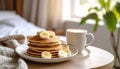 Three-quarter view of pancakes with banana slices and cappuccino Royalty Free Stock Photo