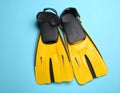 Pair of yellow flippers and mask on light blue background, flat lay. Space for text Royalty Free Stock Photo