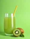 Glass of refreshing drink and cut kiwi on green background, space for text Royalty Free Stock Photo