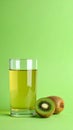 Glass of refreshing drink and cut kiwi on green background, space for text Royalty Free Stock Photo
