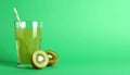 Glass of refreshing drink and cut kiwi on green background, space for text Royalty Free Stock Photo