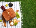 Flat lay composition with picnic basket and products on checkered blanket outdoor Royalty Free Stock Photo