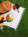 Flat lay composition with picnic basket and products on checkered blanket outdoor Royalty Free Stock Photo