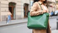 Woman with stylish green bag on city street, closeup Royalty Free Stock Photo