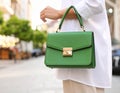 Woman with stylish green bag on city street, closeup Royalty Free Stock Photo