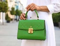 Woman with stylish green bag on city street, closeup Royalty Free Stock Photo