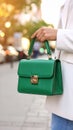 Woman with stylish green bag on city street, closeup Royalty Free Stock Photo