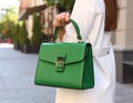 Woman with stylish green bag on city street, closeup Royalty Free Stock Photo